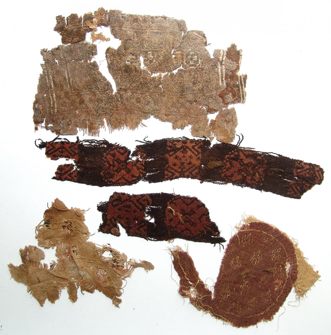 A group of 5 Coptic textile fragments, Egypt: A group of 5 Coptic textile fragments, Egypt, c. 5th - 7th Century AD. A variety of examples are present including a round medallion in a pale purple, a fragmentary rectangular panel with geometric an