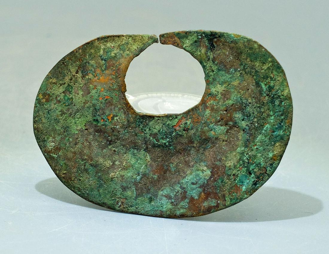 A large Quimbaya nose ornament from Colombia: A large tumbaga Quimbaya nose ornament, Colombia, c. AD 1000 - 1500. W: 3 in (7.6 cm). Heavy mineral deposits. Cf. Barradas, 'Orfebreria Prehispanica de Colombia', plate 211. Ex Melnick collection.