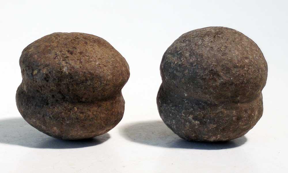 A pair of Inca stone bolo weights: A pair of Inca bolo weights, c. AD 1300 - 1500, carved from basalt or granite. L: 1 7/8 in (4.8 cm) & 1 3/4 in (4.4 cm). Nice examples of ancient weaponry. Ex Irons estate, TX.