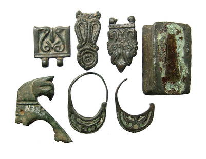 A nice group of 7 Seljuk bronze objects: A nice group of 7 Seljuk bronze objects. c. 12th - 13th Century, an includes a bronze pedestal, pair of large earrings with areas for inlay, a handle with head of a griffin with remains of iron from