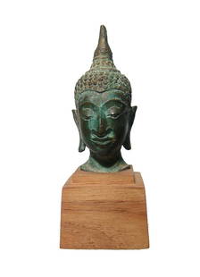 A nice bronze head of Buddha, Thailand: A nice bronze head of Buddha, Thailand, 18th - 19th Century, with detailed features and hair in tight curls. H: 3 in (7.6 cm). Nicely patinated, on old wood base. Ex Los Angeles private collection.