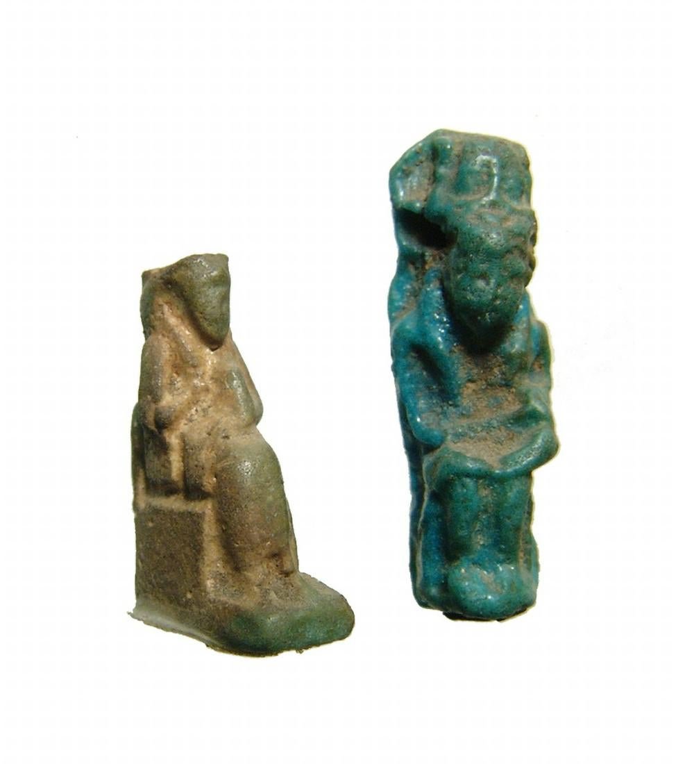 A pair of Egyptian faience amulets of Isis and Horus: A pair of Egyptian faience amulets of Isis and Horus. The first is a green faience amulet of seated Isis, Late Period, c. 664 - 30 BC, who suckles the infant Horus who sits in her lap, H: 22 mm, the s