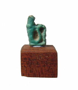 An Egyptian faience amulet of a cobra, Late Period: An Egyptian faience amulet of a cobra, Late Period, c. 664 - 30 BC, with attractive turquoise color and mounted on a wood block base. H: 1.5 cm. Ex collection of J.D.R. Fryer, UK.