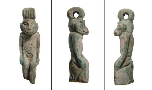 Rare and well-detailed faience amulet of a monkey: A rare and well-detailed faience green-glazed amulet of a standing monkey, Late Period, c. 664 - 30 BC, depicted seated with hands at side, suspension loop atop head. Unlike the baboon, the Vervet