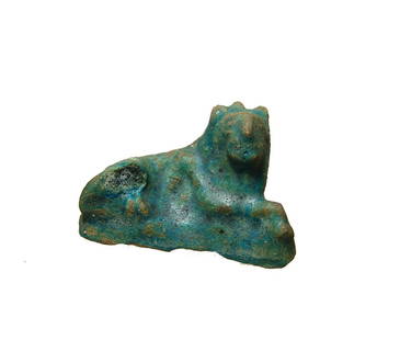 Egyptian blue-glazed composition figure of a lion: An Egyptian blue-glazed composition figure of a reclining lion, Graeco-Roman, 2nd Century BC - 2nd Century AD, richly detailed lion with a recumbent head, turned sharply to the right and facing