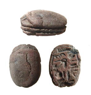 An Egyptian steatite scarab, New Kingdom: An Egyptian steatite scarab, New Kingdom, c. 1570 - 1075 BC, the body nicely carved and with a hieroglyphic inscription on the base. 15 x 11 mm. Holed lengthwise for suspension. Ex collection of