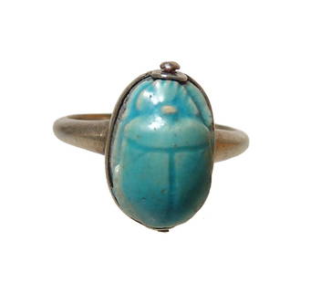 An Egyptian faience scarab in silver ring: An Egyptian faience scarab in silver ring. The scarab, Late Period, c. 664 - 332 BC, with well-preserved light blue glaze and 'Amen-Re' on the base. It is set in a custom antique silver ring which is