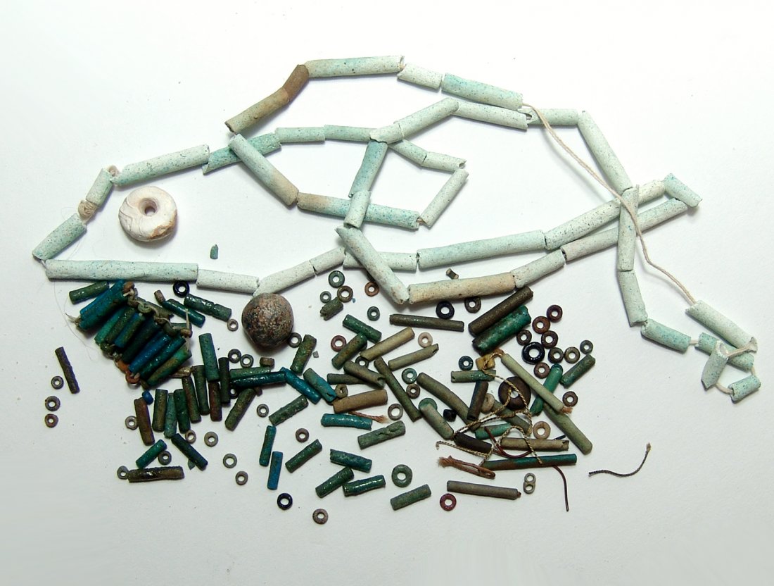 A mixed group of ancient Egyptian faience beads: A mixed group of ancient Egyptian faience beads, Late Period, c. 664 - 332 BC, mostly cylindrical in shape and in shades of blue to green. Largest bead 3.5 cm in length. Ex Southern California private
