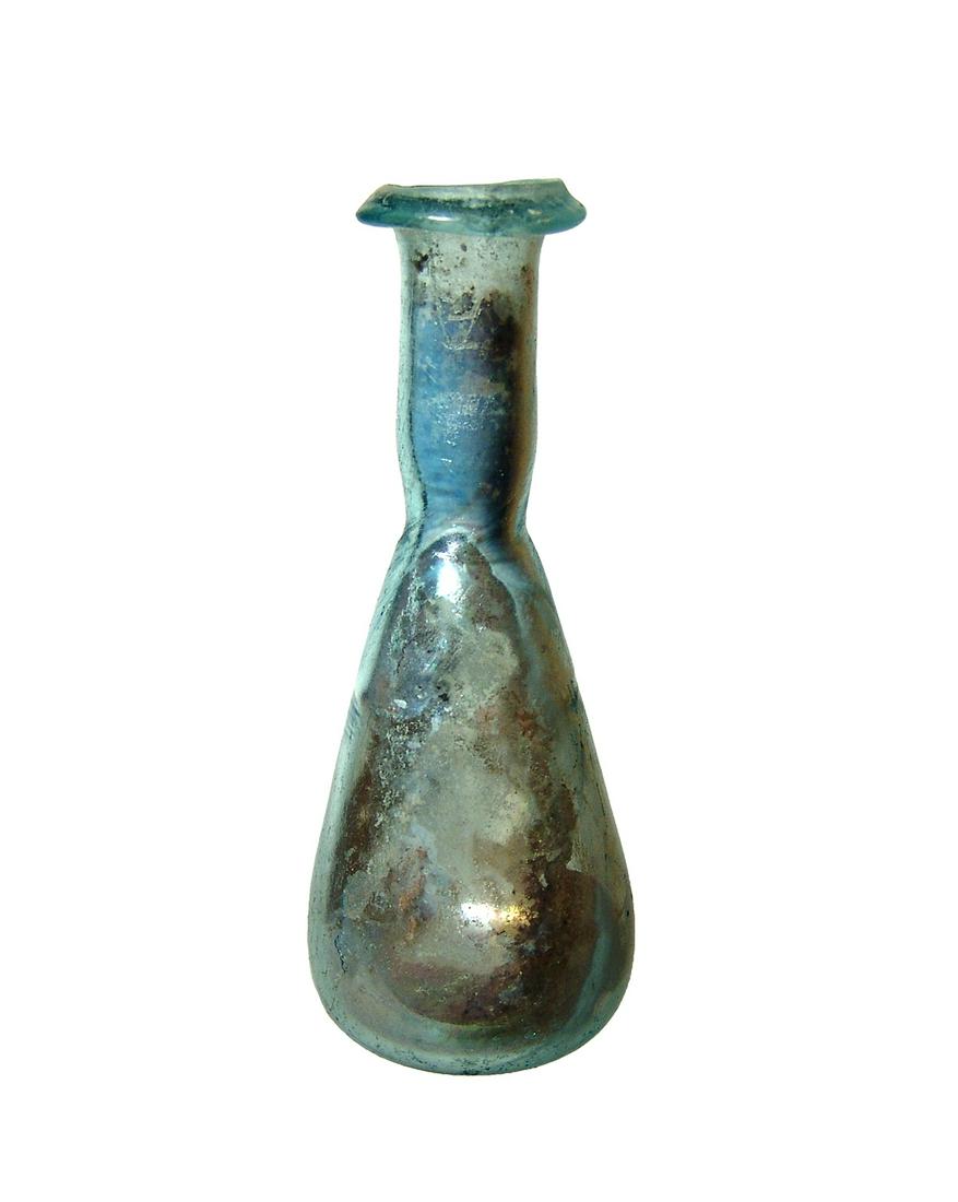 A well-preserved Roman pale blue glass vessel: A well-preserved Roman pale blue glass vessel, c. 1st - 2nd Century AD, the tapered body with flattened foot, the cylindrical neck lightly constricted at base and the rim collared. H: 3 5/8 in (9.2 cm