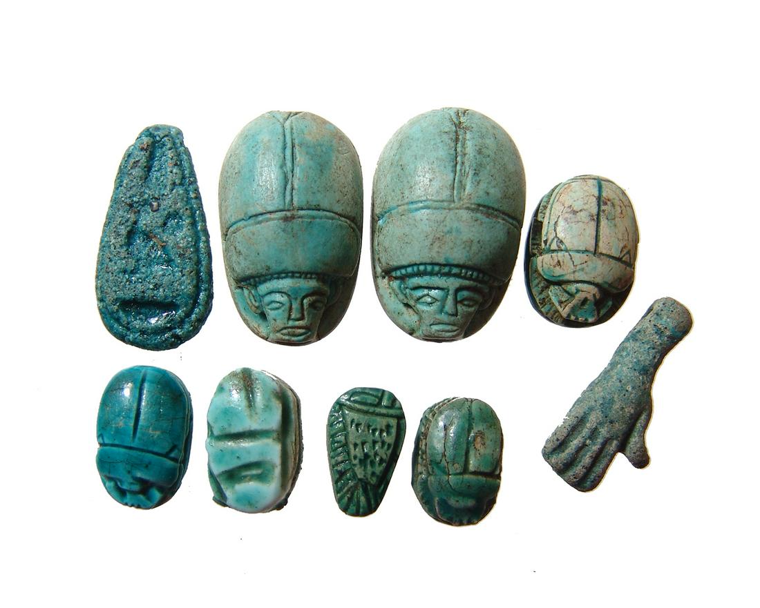 9 replica Egyptian scarabs and a hand amulet (1 of 2)