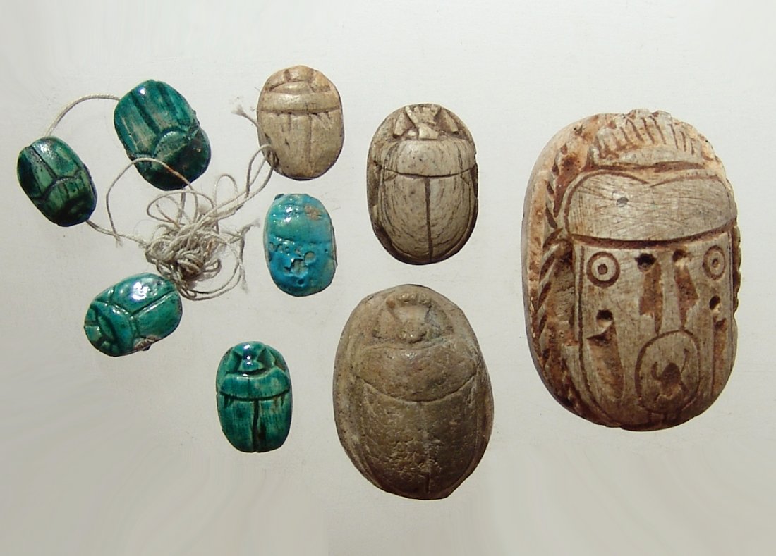 A lot of 9 attractive replica Egyptian-style scarabs: A lot of 9 attractive replica Egyptian-style scarabs. Several have brilliant blue glaze and the largest with openwork legs. 12 x 8 mm to 27 x 25 mm.