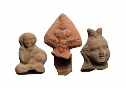 A lot of 3 Ptolemaic terracotta objects: A lot of 3 Ptolemaic terracotta objects. Lot includes a pair of molded terracottas - a head from a figure of Harpokrates and a seated figure of Harpokrates, c. 2nd Century BC/AD, and a fragment of a R