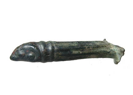 Roman bronze patera handle in the form of a ram: A Roman bronze patera handle in the form of a ram, c. 1st - 3rd Century BC, the body with vertical ribbing with two ridges at the base of the ram's head. L: 6 in (15.2 cm). Nice brown patina. Ex New Y