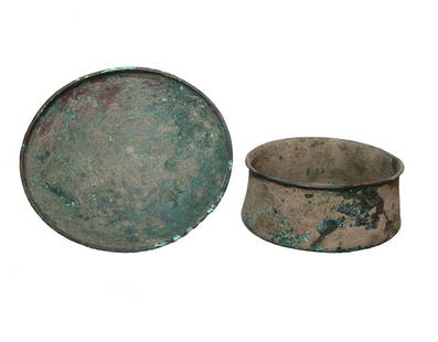 A pair of Near Eastern bronze bowls: A pair of Near Eastern bronze bowls, c. 1200 - 800 BC, the first a hemispherical bowl fashioned from sheet bronze with flattened rim, Dia: 5 1/2 in (14 cm). The second is a bronze sheet jar flared rim