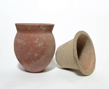 A pair of Roman pottery vessels: A pair of Roman pottery vessels, c. 1st - 4th Century AD, the first ovoid beaker with narrow foot and flared mouth, H: 5 in (12.7 cm), and the second a cup with wide rim, 3 3/8 x 4 5/8 in (8.6 x 11.7