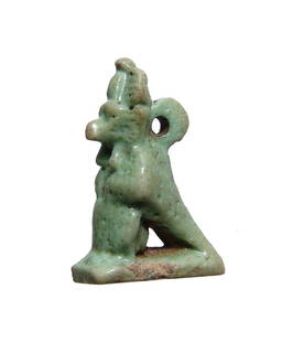 Rare Egyptian green-glazed faience hybrid amulet: A rare Egyptian green-glazed faience hybrid amulet, Late Period, c. 664 - 30 BC, in the form of a baboon with a bird's tail and wings wearing an Atef crown. The figure stands on a rectangular