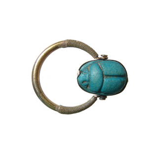 Egyptian faience scarab set in a lovely gold swivel: A choice Egyptian faience scarab set in a lovely gold swivel ring. The vibrant blue faience scarab, New Kingdom, c. 1479 - 1075 BC, with cartouche with praenomen of Thutmose III reading