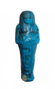 A fantastic Egyptian deep blue glazed ushabti: A fantastic Egyptian deep blue glazed ushabti, 3rd Intermediate Period, Dynasty 21, c. 1075 - 945 BC, depicted mummiform wearing striated wig, arms folded at chest and holding hoes; bag suspended at