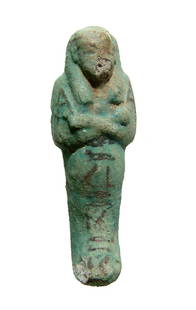 An Egyptian bicolor faience ushabti, Dynasty 21: An Egyptian bicolor faience ushabti, 3rd Intermediate Period, Dynasty 21, c. 1075 - 945 BC, depicted mummiform, wearing tripartite wig, arms folded at chest and holding a hoe in each hand. Down the