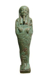 A wonderful Egyptian green glazed ushabti: A wonderful Egyptian green glazed ushabti, Late Period, Dynasty 30, c. 380 - 343 BC, depicted mummiform on integral base with plinth at back, wearing tripartite wig with false beard, arms folded at ch