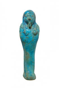 Choice Egyptian blue faience ushabti, Late Period: A choice Egyptian blue faience ushabti, Late Period, c. 664 - 343 BC, mummiform, wearing tripartite wig and false beard. Arms folded across chest, hands holding a pick and hoe, bag over left