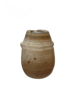 An Egyptian alabaster kohl jar, Late Period: An Egyptian alabaster kohl jar, Late Period, c. 664 - 332 BC, the pear-shaped body with rounded bottom and two small lug handles, the rim rounded and the interior well-bored allowing light through