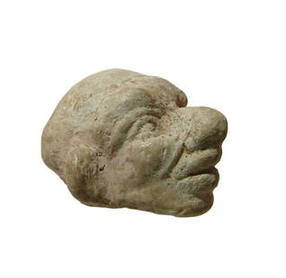 Egyptian limestone head of a man in grotesque style: An Egyptian limestone head of a man in grotesque style, possibly a priest, Ptolemaic, c. 3rd - 1st Century BC, with exaggerated features including large nose and ears and heavy brow. 1 1/2 x 1 3/8 x