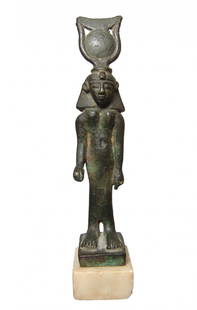 An important Egyptian bronze figure of Khonsu: An important Egyptian bronze figure of Khonsu, Late Period, c. 664 - 332 BC, wearing a shoulder length wig with uraeus surmounted by cow's horns and a solar disc and the crescent moon. The features