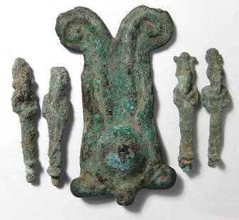 A group of Egyptian bronze objects: A group of Egyptian bronze objects, Late Period, c. 664 - 332 BC, and including a large headdress from a figure of a deity with cow's horns and solar disk, 4 1/4 x 2 1/4 in (10.7 x 5.7 cm), as well as