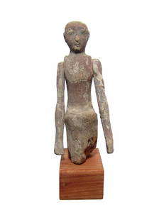 A nice Egyptian painted wood figure, Middle Kingdom: A nice Egyptian painted wood figure, Middle Kingdom, c. 2061 - 1690 BC, from a large model wood boat or a scene from daily life. He is depicted seated with carved face and black cosmetic details. He