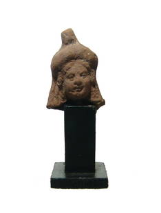 A Romano-Egyptian terracotta head of Isis: A Romano-Egyptian terracotta head of Isis, c. 1st - 2nd Century AD, wearing a small solar headdress, her hair in long braids. H: 2 1/2 in (6.3 cm). Light deposits, old wood base. Ex North Carolina