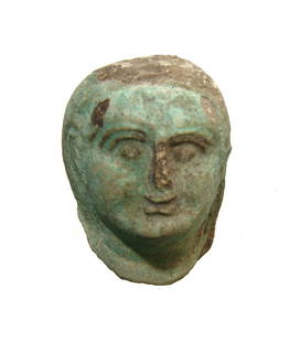 A neat Egyptian glazed composition head of a woman: A neat Egyptian glazed composition head of a woman, Late Period - Ptolemaic, c. 664 - 30 BC, with raised details in black. Part of a larger composition, the piece is well-preserved with facial style