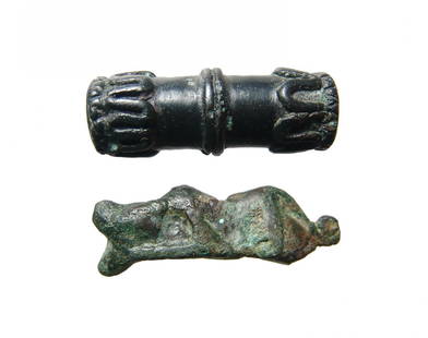 A pair of Near Eastern bronze elements: A pair of Near Eastern bronze elements. Each is attractive, c. 1200 - 600 BC, the first the terminal of a clothes pin in the form of a graceful feline, 1 5/8 in (4.1 cm), the second is a tubular bead