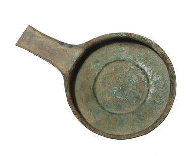 An Etruscan bronze handled pan or patera: An Etruscan bronze handled pan or patera, c. 3rd - 2nd Century BC, fashioned from sheet bronze with circular flat base, flared rim and long handle with raised edges. 8 1/8 x 5 1/4 in (20.6 x 13.3