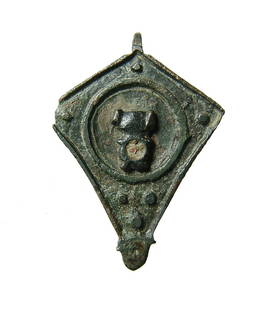 A Roman bronze seal box lid: A Roman bronze seal box lid, 1st - 3rd Century AD, diamond-shaped with a raised element containing remnants of inlay within a circle. The entire lid is bordered by a ridge with raised circles