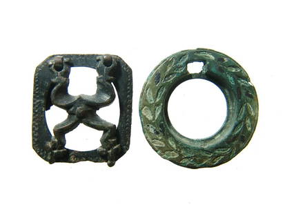 A pair of Roman & Persian bronze inkwell lids: A pair of Roman & Persian bronze inkwell lids. The first is a circular lid with incised floral decoration and square opening for attachment of the lid, 1 1/4 in (3.2 cm). The second is a lid from a