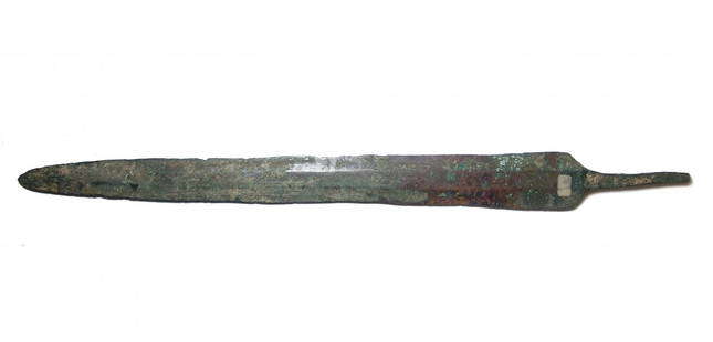 A nice Near Eastern bronze sword blade: A nice Near Eastern bronze sword blade, c. 1200 - 800 BC, the long tapering blade with wide, flat midrib, the shoulders angled and with long tang for attachment of a handle. L: 16 1/4 in (41.2cm).