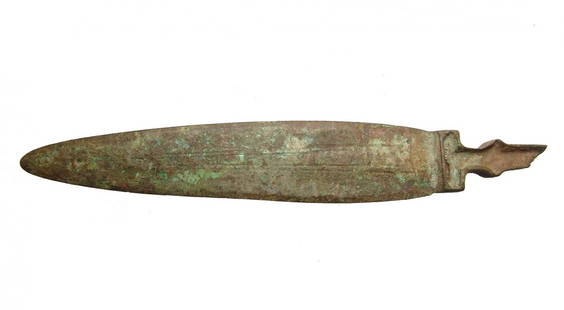 A Near Eastern bronze dagger blade: A Near Eastern bronze dagger blade, c. 1000 - 600 BC, the leaf-shaped blade is narrow with incised midrib, the handle with vertical flange to hold an inlay of another material. The blade and handle ap