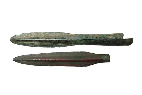 A pair of bronze javelin points: A pair of bronze javelin points. The first is an early Greek type, c. 1200 - 800 BC, with narrow tongue-like blade possessing a blunted tip and fissured tube, L: 6 1/2 in (16.4 cm). The second is a