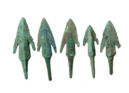 A nice lot of 5 Near Eastern bronze arrow points: A nice lot of 5 Near Eastern bronze arrow points, c. 1000 - 600 BC, each with triangular blade with pronounced midribs, the substantial stems with long tang for mounting into a shaft. Largest 2 in (5