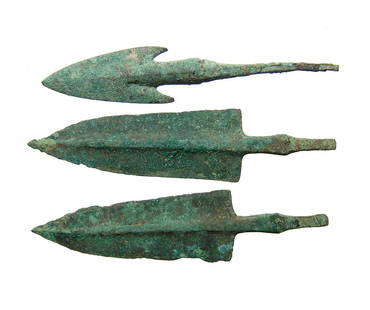 A lot of 3 nice Near Eastern bronze arrow points: A lot of 3 nice Near Eastern bronze arrow points, c. 1200 - 800 BC, 2 with pronounced midrib and tapered blade and another with barbed shoulders. Each with slender stems for mounting into the shaft.