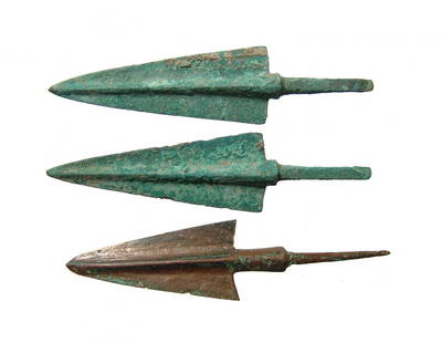 A lot of 3 choice Near Eastern bronze arrow points: A lot of 3 choice Near Eastern bronze arrow points, c. 1200 - 800 BC, each with pronounced midrib, tapered blade and squared shoulders. Each with slender stems for mounting into the shaft. Largest 4