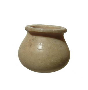 A Sumerian creme marble jar: A Sumerian creme marble jar, c. 3000 - 2500 BC, with rounded body and wide mouth with flattened rim. The interior is vertically bored with concentric drilling rings and thick walls. 2 1/8 x 1 3/4 in