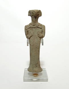 A nice Near Eastern terracotta Astarte figurine: A nice Near Eastern terracotta Astarte figurine, c. 1500 - 1000 BC, with tall columnar body, bird-like features, and large circular eyes. Her hands are on her midsection and she wears a collar or