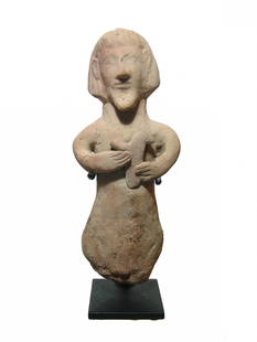 A Cypriot terracotta figure of a bearded man: A Cypriot terracotta figure of a bearded man, c. 750 - 475 BC, with angular features, Egyptian-style hair and holding a bird in his hand, likely a dove. He appears nude, his genitalia indicated near