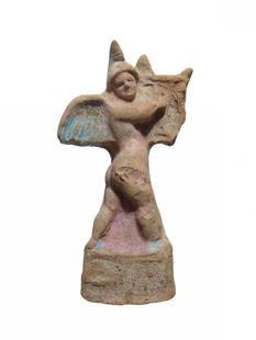 Wonderful Greek terracotta figurine of a winged Erote: A wonderful Greek terracotta figurine of a winged Erote, Canosan, c. 4th - 3rd Century BC, depicted nude standing on a square base, wearing Phrygian style cap and walking to right plucking the