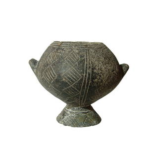 A nicely incised Yortan black-ware vessel: A nicely incised Yortan black-ware vessel, Anatolia, Early Bronze Age II, c. 2700 - 2400 BC, the rounded body and flared foot beautifully incised with geometric designs, the two lug handles pierced