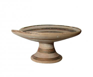 An attractive Cypriot or South Italian pedestal dish: An attractive Cypriot pedestal dish, c. 750 - 600 BC, or possibly South Italian, c. 5th-4th Century BC, the shallow dish decorated with concentric rings in dark brown slip which extend onto the