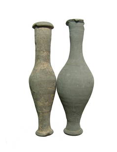 A cute pair of Greek spindle vessels: A cute pair of Greek spindle vessels, c. 2nd - 1st Century BC, one said to be from Aptera. Both in a grey buff ware with light deposits. H: 4 3/8 in (11.2 cm) & 4 1/2 in (11.4 cm). Some rim chipping,