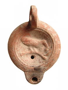 Roman ceramic discus lamp depicting bird on branch: A Roman ceramic discus lamp depicting a bird on branch, late 1st - early 2nd Century AD, the discus depicting a bird standing on a branch, bordered by grooves and ridges, the nozzle short and round